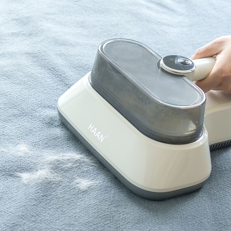 Haan UV Bedding Vacuum Cleaner in action on mattress fabric