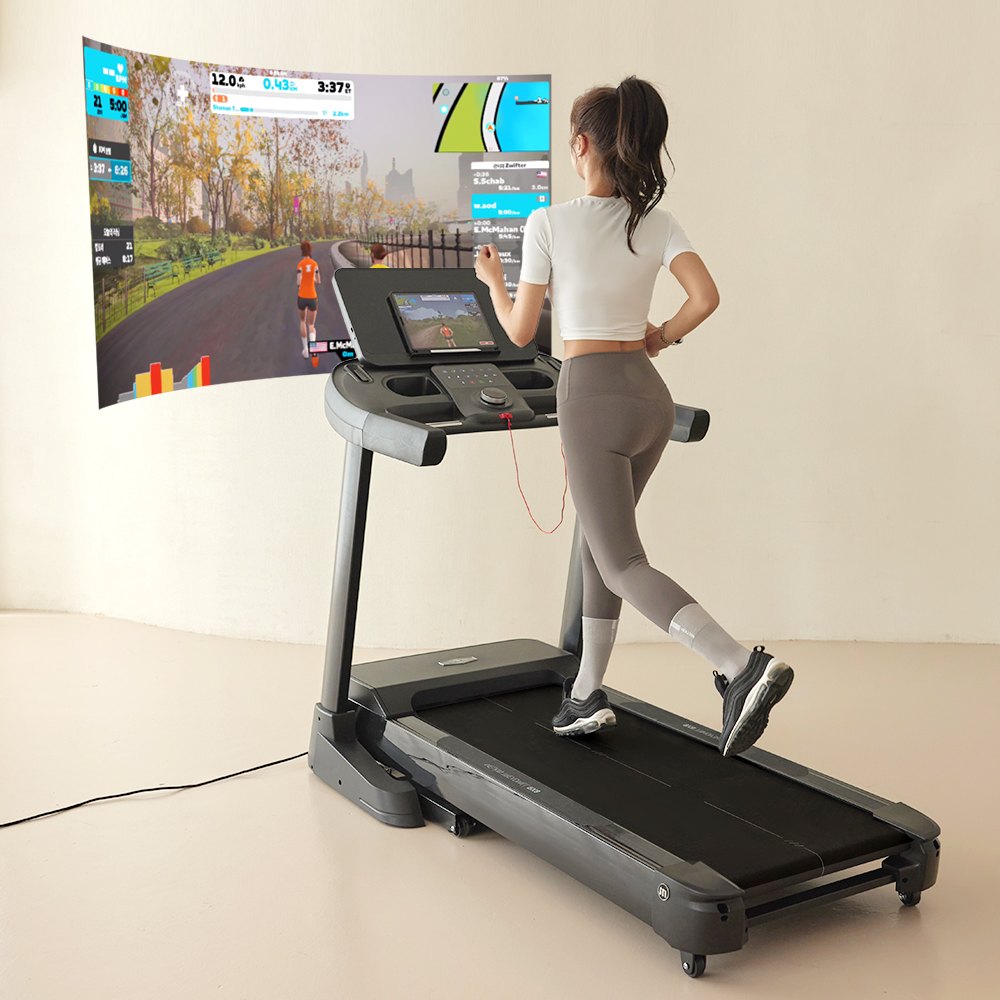 Melkin RX8 treadmill in use with a large screen virtual course
